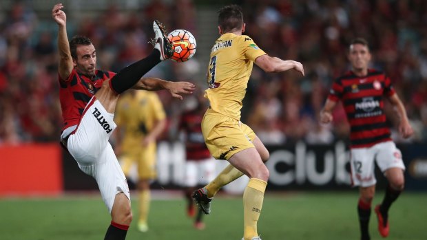 Good skills:  Alberto of the Wanderers clears the ball as Roy O'Donovan of the Mariners takes evasive action.