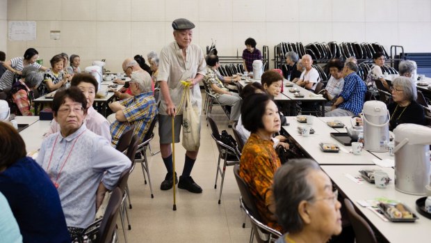 Yoshikazu Kinoshita arrives at one of the monthly lunches for tenants who live alone.