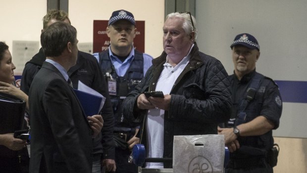 Concert promoter Andrew McManus being detained by police at Melbourne Airport on Thursday night.