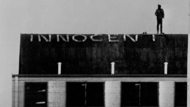 Convicted murderer John Andrew Stuart pictured in November 1977 on the roof of Brisbane jail, where he knocked out bricks to spell out the word "Innocent".