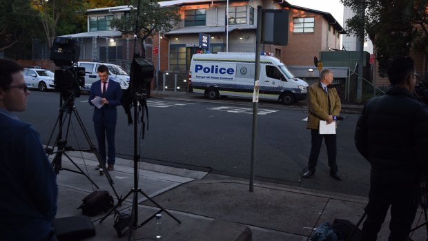 The media gather outside Merrylands Police Station on Friday morning.