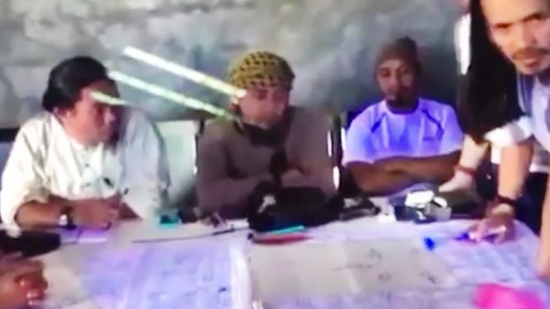The purported leader of the Islamic State group Southeast Asia branch, Isnilon Hapilon, center, at a meeting of militants at an undisclosed location.