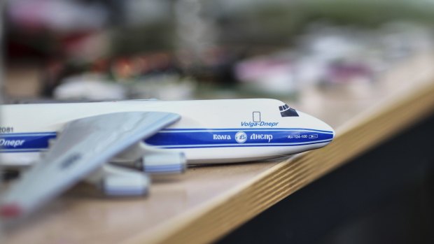 A model of a plane is placed among flowers at the Volga-Dnepr Airlines headquarters in Ulyanovsk, Russia on Monday for the six Russians killed in the Mali attack.