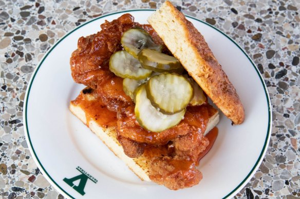 Fried chicken sandwich with deep-fried meat, hot honey butter and crinkle-cut pickles.