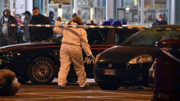 Italian investigators at the scene of a shootout between police and Anis Amri in Milan on Friday.