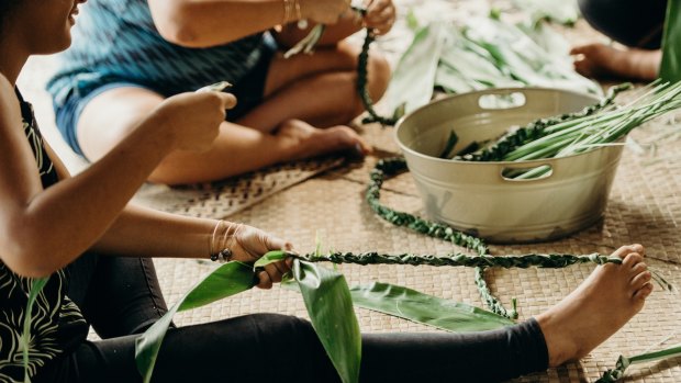 Traditional lei making by Oahu women.