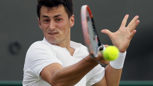 Bernard Tomic in action against Radu Albot at Wimbledon.