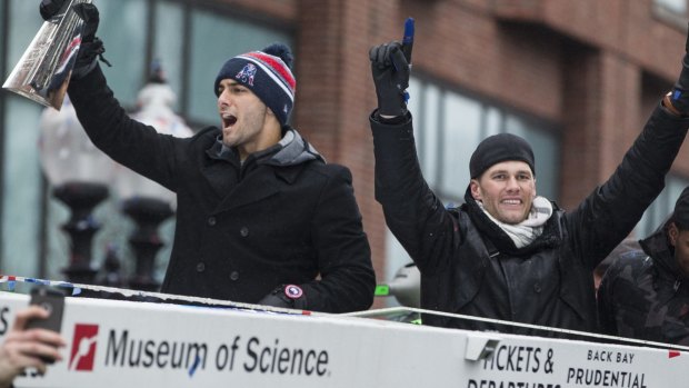 Too good: New England Patriots quarterbacks Jimmy Garoppolo and Tom Brady acknowledge the crowd.
