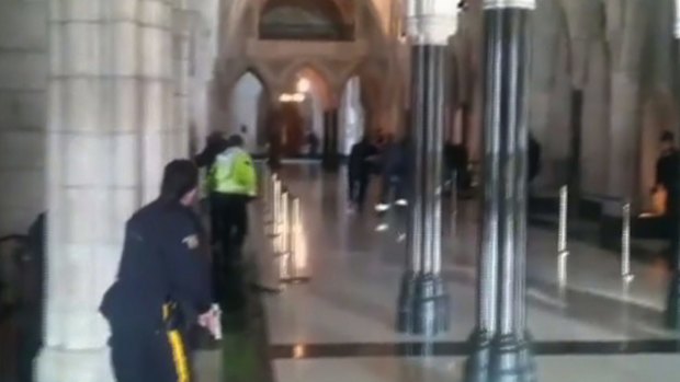 Police officers respond to shooting attacks inside the Centre Block of the Parliament buildings in Ottawa.