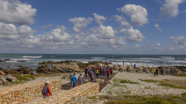 Visitors at Cape Agulhas, the southern-most tip of the African continent and the beginning of the dividing line between the Atlantic and Indian Oceans. 