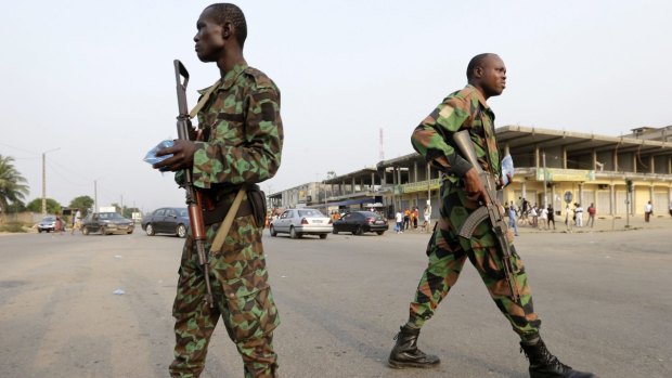 Soldiers involved in a mutiny control a street in Abidjan, Ivory Coast in January.