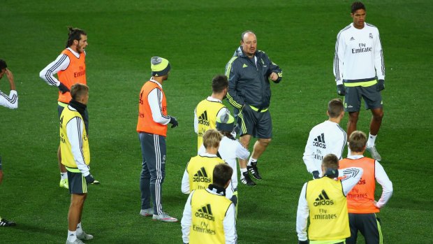 Real Madrid coach Rafael Benitez speaks to his players during training session at the MCG. 