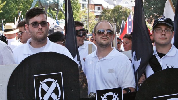 James Alex Fields jnr, left, holds a black shield at the rally in Charlottesville.