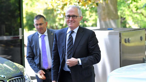 All smiles: Prime Minister Malcolm Turnbull arrives at 4 Treasury Place in Melbourne for a meeting with Opposition Leader Bill Shorten.