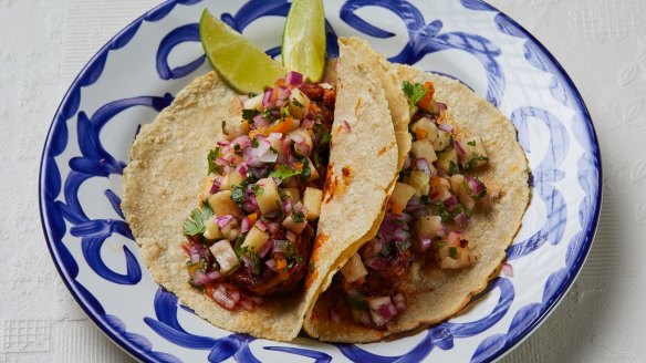 A pair of prawn and pineapple tacos.