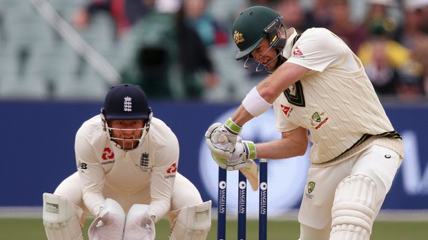 Attack: Tim Paine drives the ball in front of England's Jonny Bairstow.