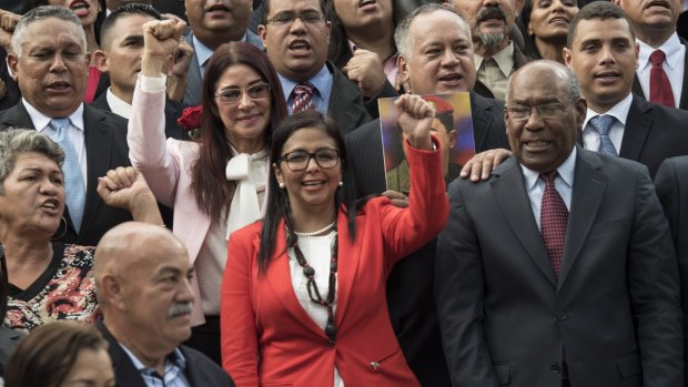 Delcy Rodriguez, president of the Constituent Assembly and Aristobulo Isturiz, first vice president of the Constituent Assembly, stand with members of the Assembly.