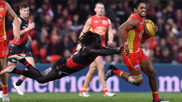 Launching into finals: Essendon's Anthony McDonald-Tipungwuti tackles Gold Coast's Aaron Hall in round 22.