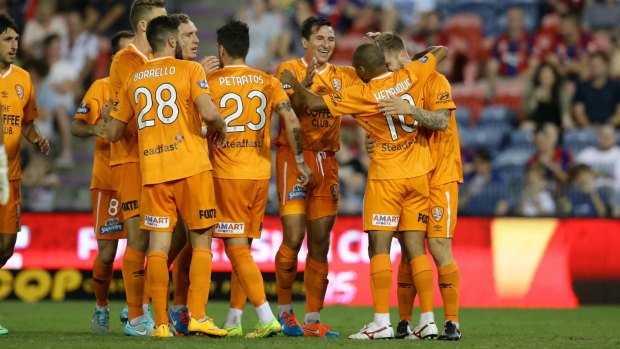 Brisbane Roar celebrate their first win of this A-League season.