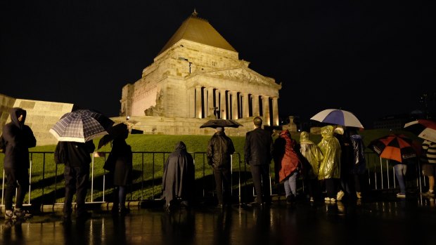 Hundreds of people gather at the Shrine of Remembrance for the ANZAC Day dawn service. 