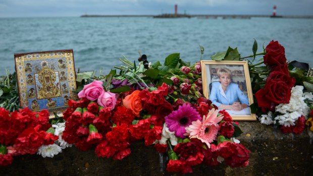 A portrait of charity worker Yelizaveta Glinka killed in the crash is placed at a memorial at a pier in Sochi.