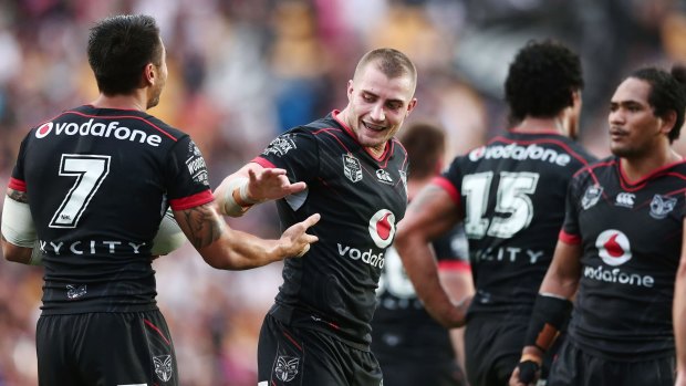 Back with a bang: Kieran Foran celebrates with teammates after scoring a try in his comeback game against the Titans.
