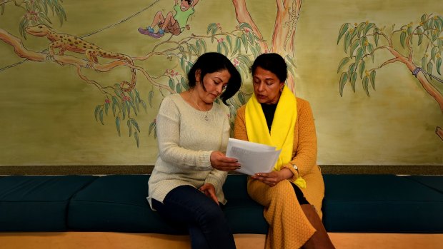 Syrian refugee Jumana Danoun, 42, (left) with her English conversation class teacher Rina Jogia (right) at the Merrylands Library.