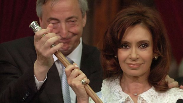Cristina Fernandez grabs the presidential cane from her husband and predecessor Nestor Kirchner, after being sworn in as Argentina's first elected female president in 2007.