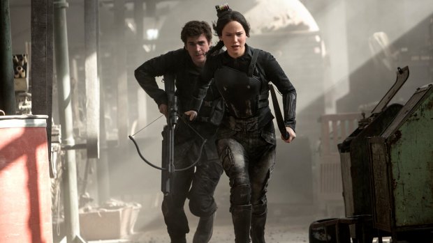 Katniss and Gale in an action scene from <i>The Hunger Games: Mockingjay - Part 1</i>.