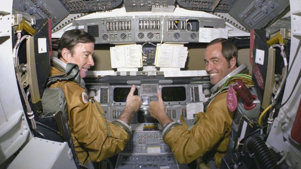 Astronauts for the first space shuttle mission, Commander John Young and Pilot Robert Crippen, take a break from their intensive training schedule to pose for pictures on the flight deck of the space shuttle Columbia in 1980. 