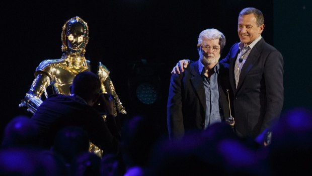 <i>Star Wars</i> director George Lucas, centre, with C3PO, left, and Disney chief Bob Iger.