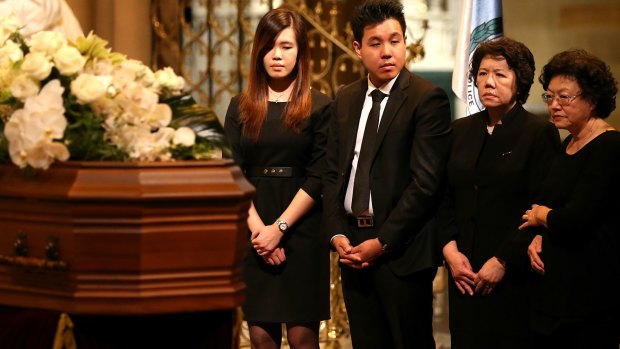 The family of Curtis Cheng stand by his coffin.