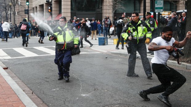 Police officers use pepper spray on anti-Trump protesters in Washington. 