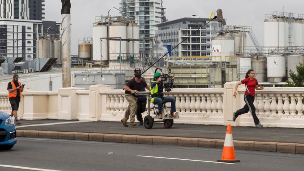 Brisbane plays a starring role in Australia Day, directed by Kriv Stenders. Pictured is Miah Madden running across the William Jolly Bridge.