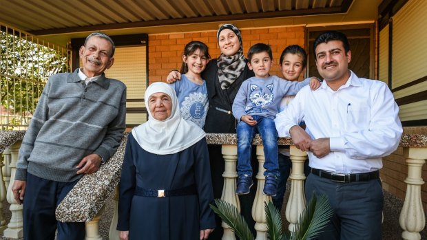 Syrian refugee Anwar Rostom (right) with his parents, wife and children. The family arrived in Australia last year.