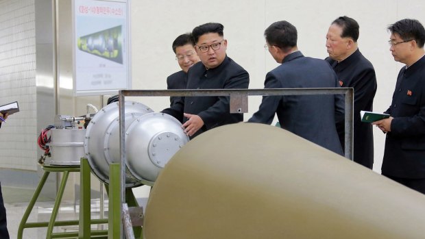 In this undated image distributed on Sunday by the North Korean government, North Korean leader Kim Jong-Un is said to be inspecting the loading of a hydrogen bomb into a new intercontinental ballistic missile.
