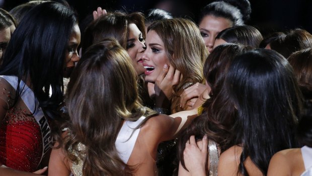 Other contestants comfort Miss Colombia Ariadna Gutierrez, centre, in tears after she was incorrectly crowned Miss Universe.