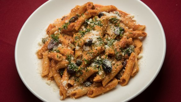 Penne puttanesca pinging with garlic, anchovies and tomatoes.