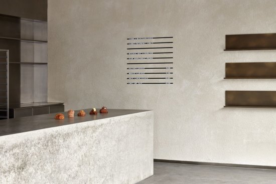 The store features many of Lune's design signatures, such as a minimalist aesthetic and poured concrete surfaces.