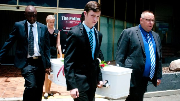 Karl Sisson and his son Jordan carry the coffin at the funeral.