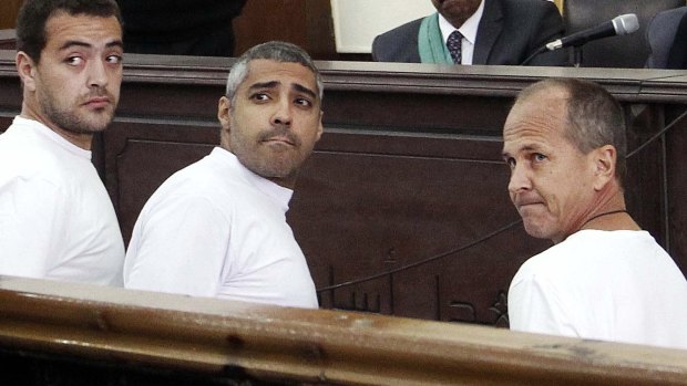 Peter Greste (right) appears in court along with other defendents during their trial on terror charges in Cairo, Egypt.