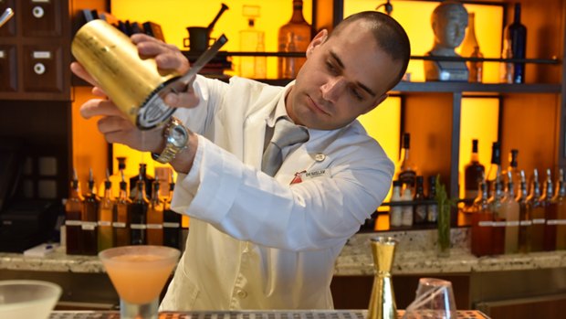 A barman makes a cocktail to order.
