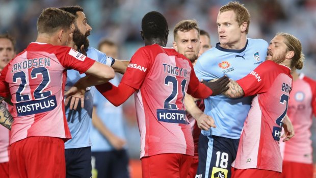 Flashpoint: Luke Brattan of Melbourne City holds back Matt Simon as he exchanges heated words with Michael Jakobsen.