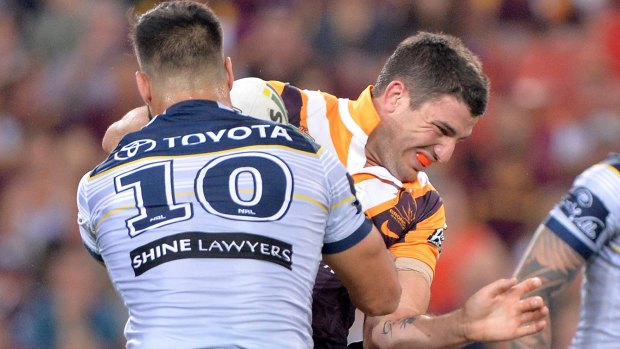 No try: Matt Gillett of the Broncos takes on the Cowboys' defence.