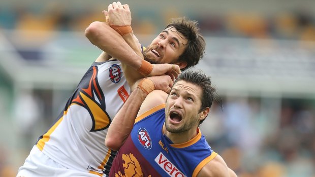 Hang in there: Josh Kennedy of the Eagles and Lion Stefan Martin compete.