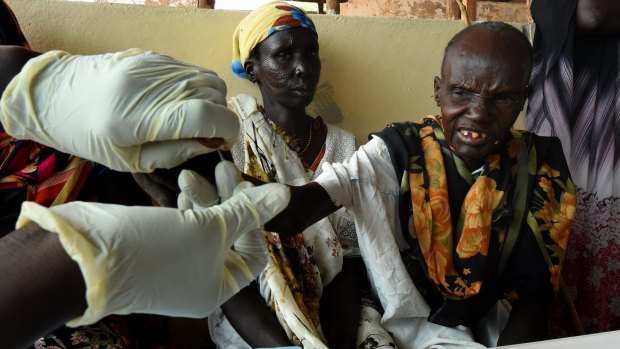 A Medecines Sans Frontieres (MSF) health worker tests villagers for malaria in South Sudan.