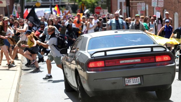 A vehicle drives into a group of protesters demonstrating against a white nationalist rally in Charlottesville.