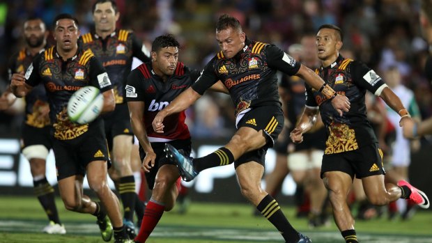 Downtown: Aaron Cruden clears the ball. His wayward kicking off the tee opened the door for the Crusaders.