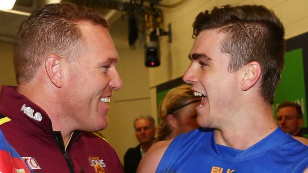 Justin time:  Lions coach Leppitsch and Ben Keays celebrate after beating the Bombers at Etihad Stadium.