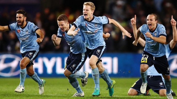 Ecstatic: Sydney FC players celebrate winning the grand final penalty shootout.